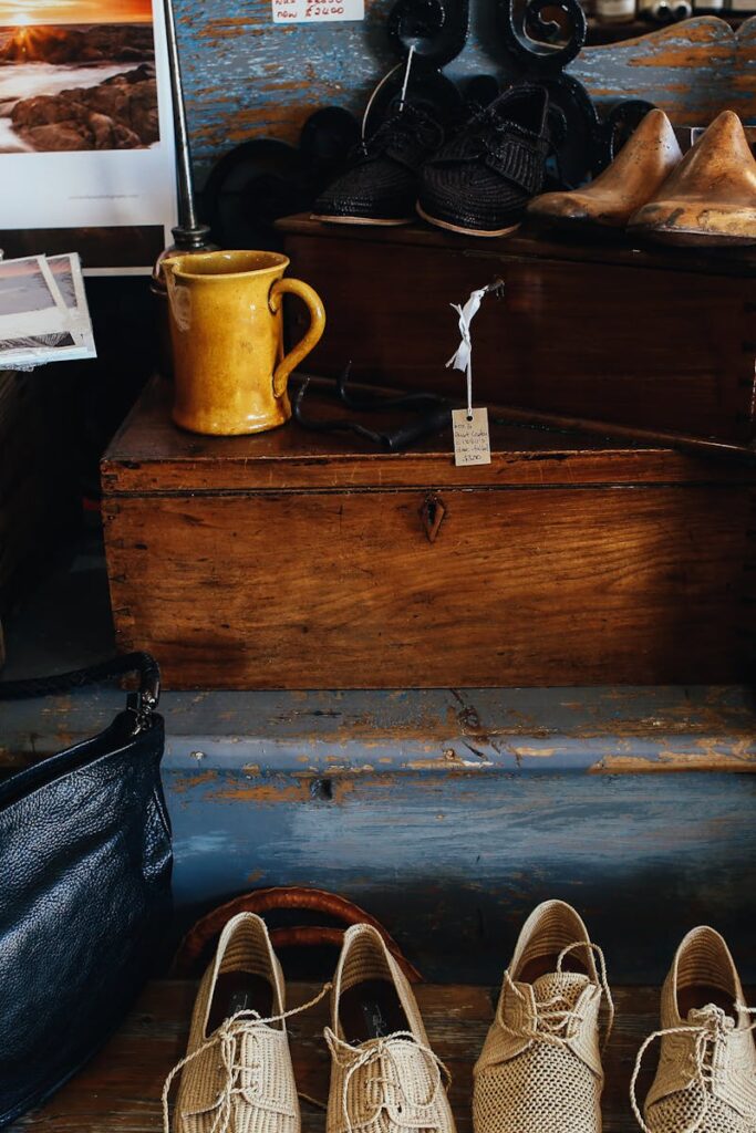 A charming display of vintage shoes, bags, and decor inside a rustic store setting.